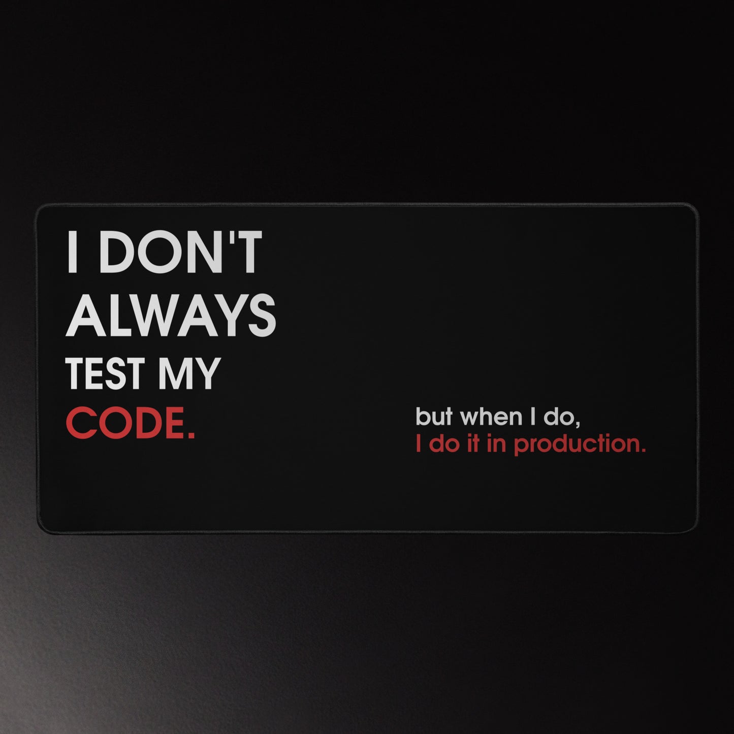 Funny developer desk mat on black with white and red typography reading I Don't Always Test My Code I Do It in Production