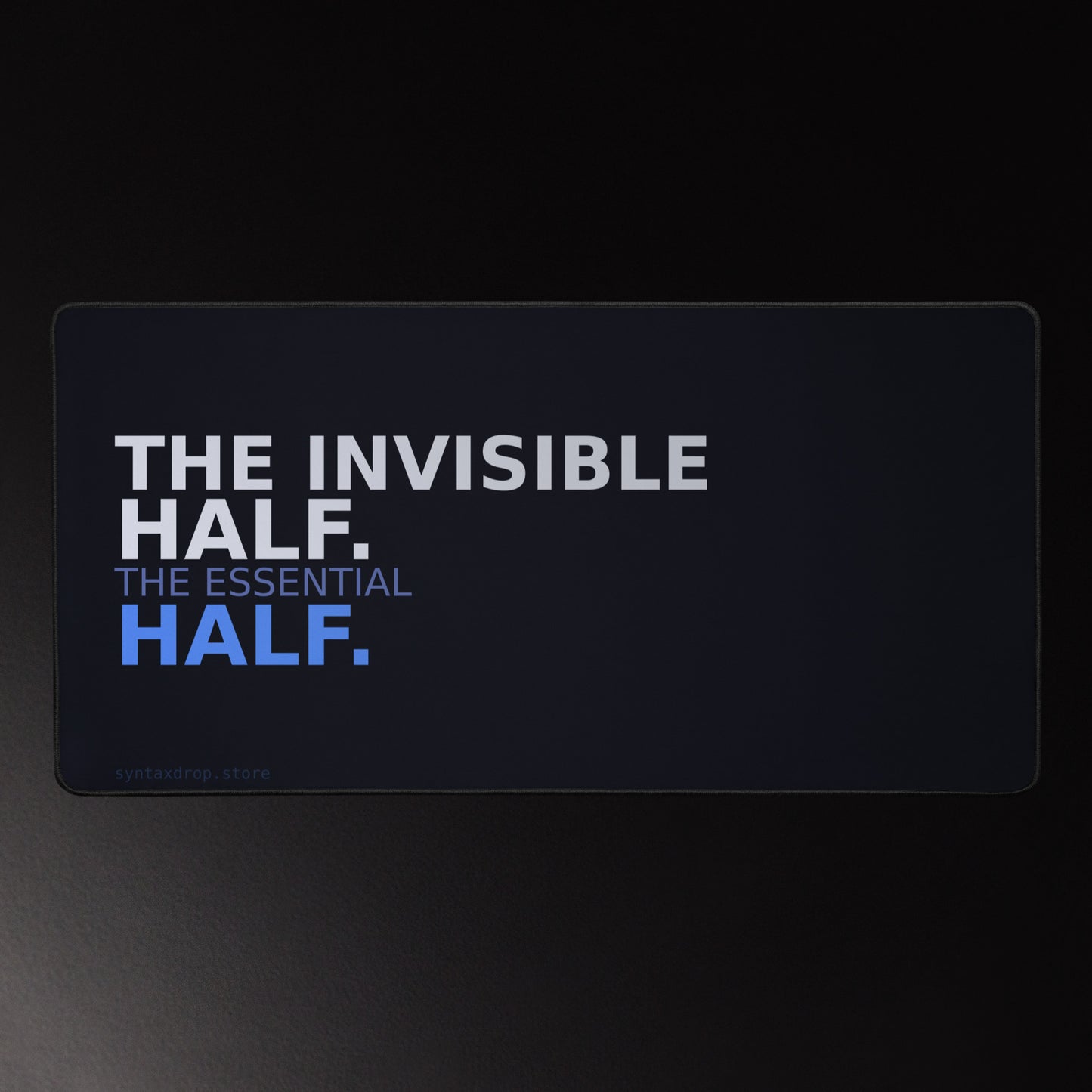 Backend developer desk mat on dark navy with bold white and blue typography reading The Invisible Half The Essential Half