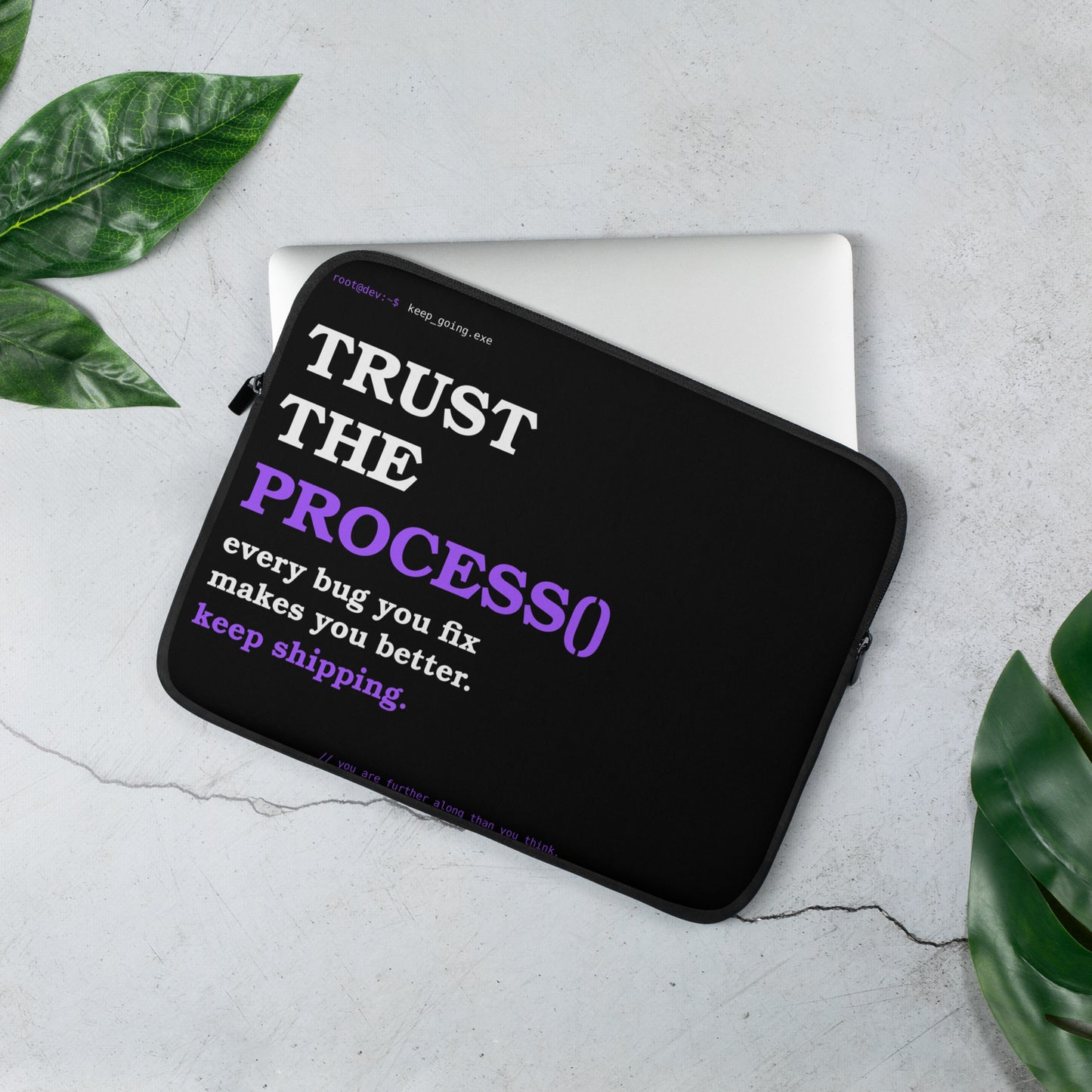 Developer laptop sleeve on black with bold white and purple serif typography reading Trust the Process and terminal prompt design