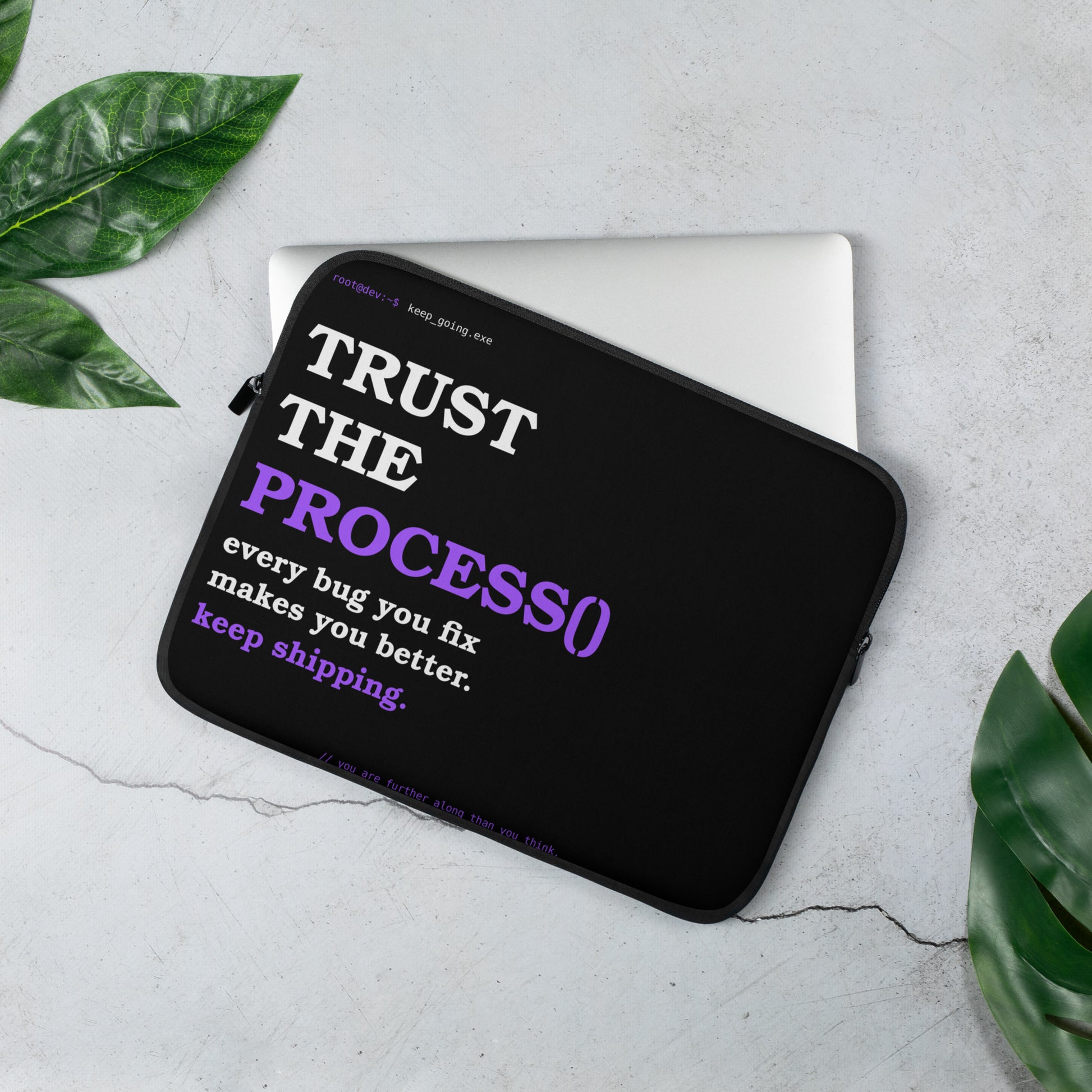 Developer laptop sleeve on black with bold white and purple serif typography reading Trust the Process and terminal prompt design
