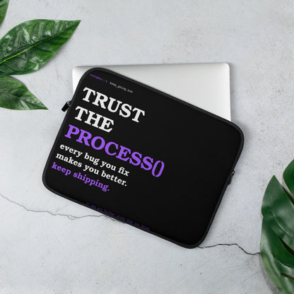 Developer laptop sleeve on black with bold white and purple serif typography reading Trust the Process and terminal prompt design