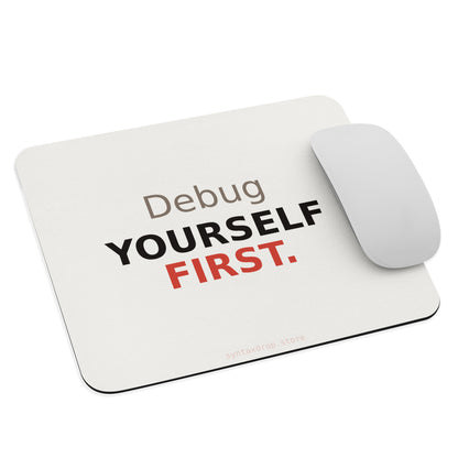 Programmer mouse pad on cream background with bold black and red typography reading Debug Yourself First
