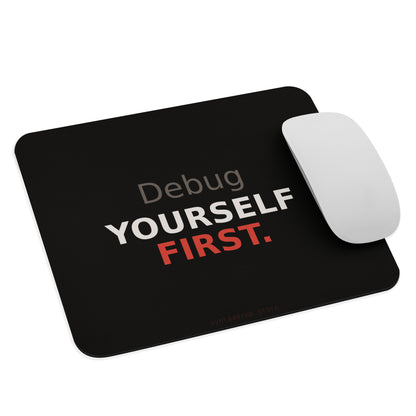 Programmer mouse pad on black background with bold white and red typography reading Debug Yourself First